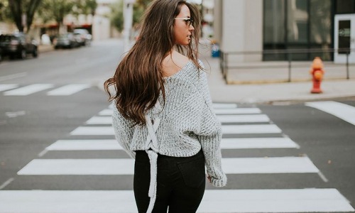 a woman standing in a crosswalk