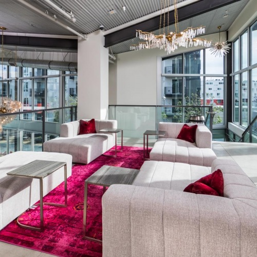 Find your perfect fit at Aliso Apartments a room with a couch and a table with chairs